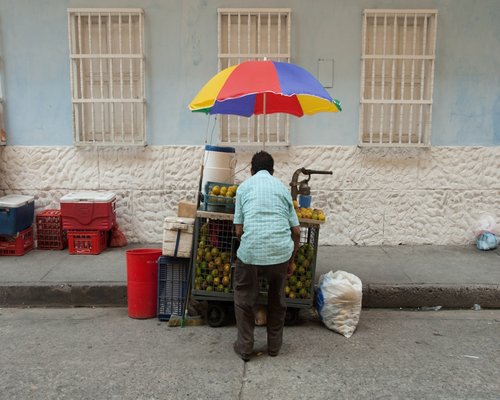 Woman drinking water in a sunny Colombian morning setting